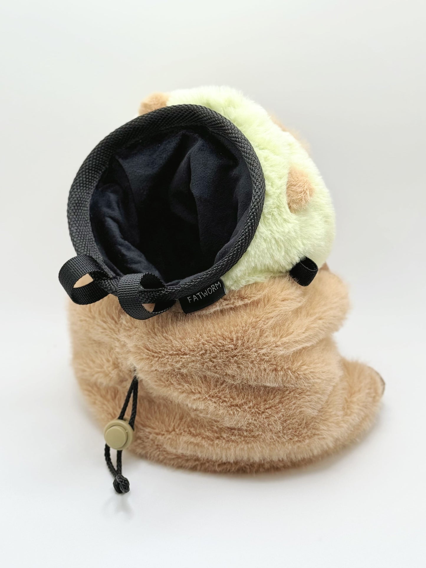 Handmade capybara-shaped climbing chalk bag dressed as a dinosaur, clutching a bubble tea cup