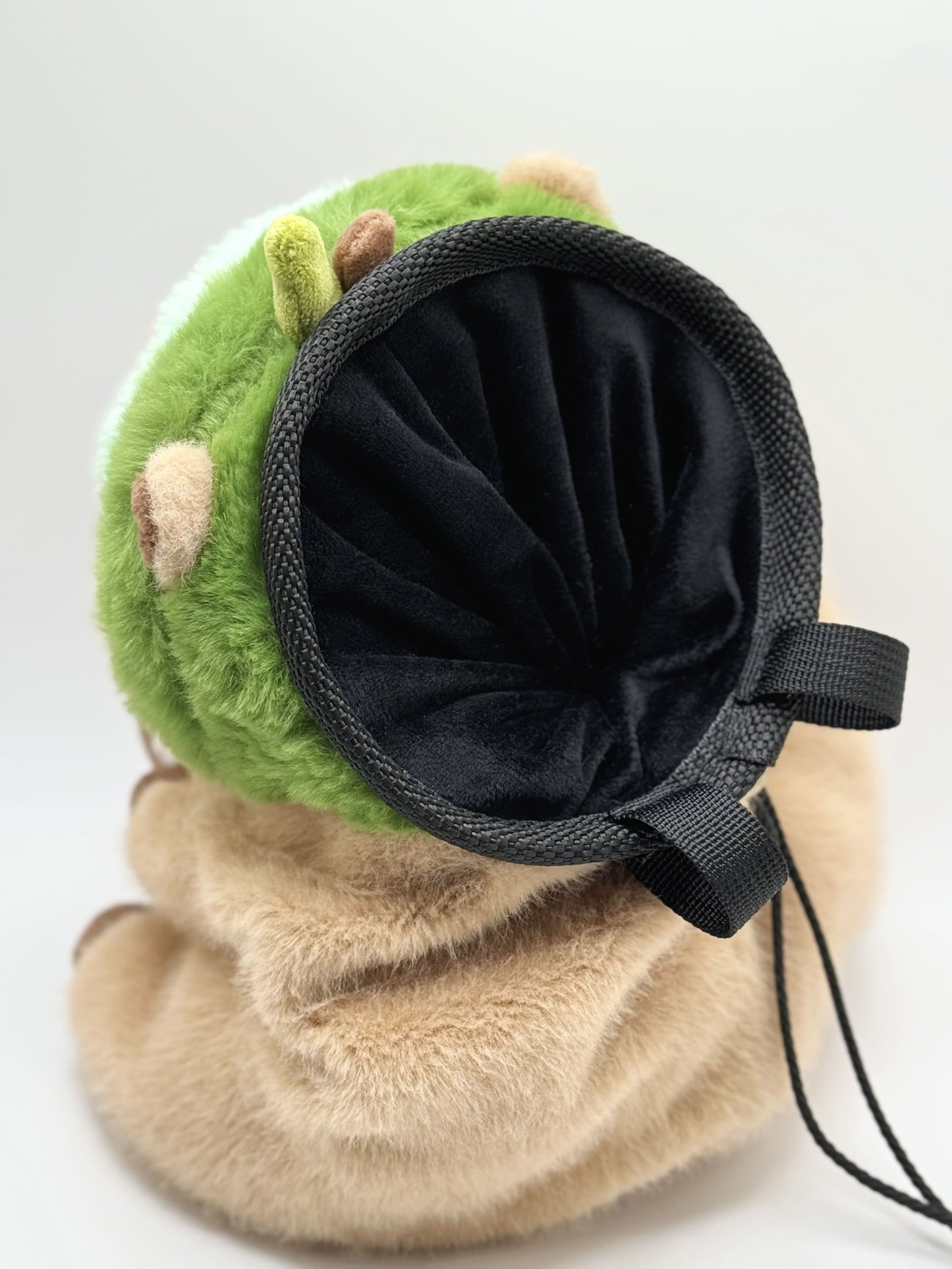 Handmade capybara-shaped climbing chalk bag dressed as avocado clutching a bubble tea cup