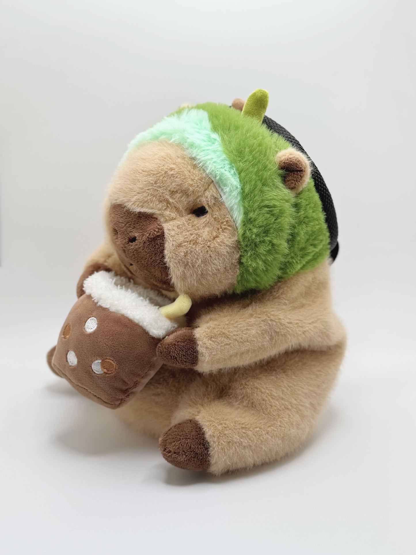 Handmade capybara-shaped climbing chalk bag dressed as avocado clutching a bubble tea cup