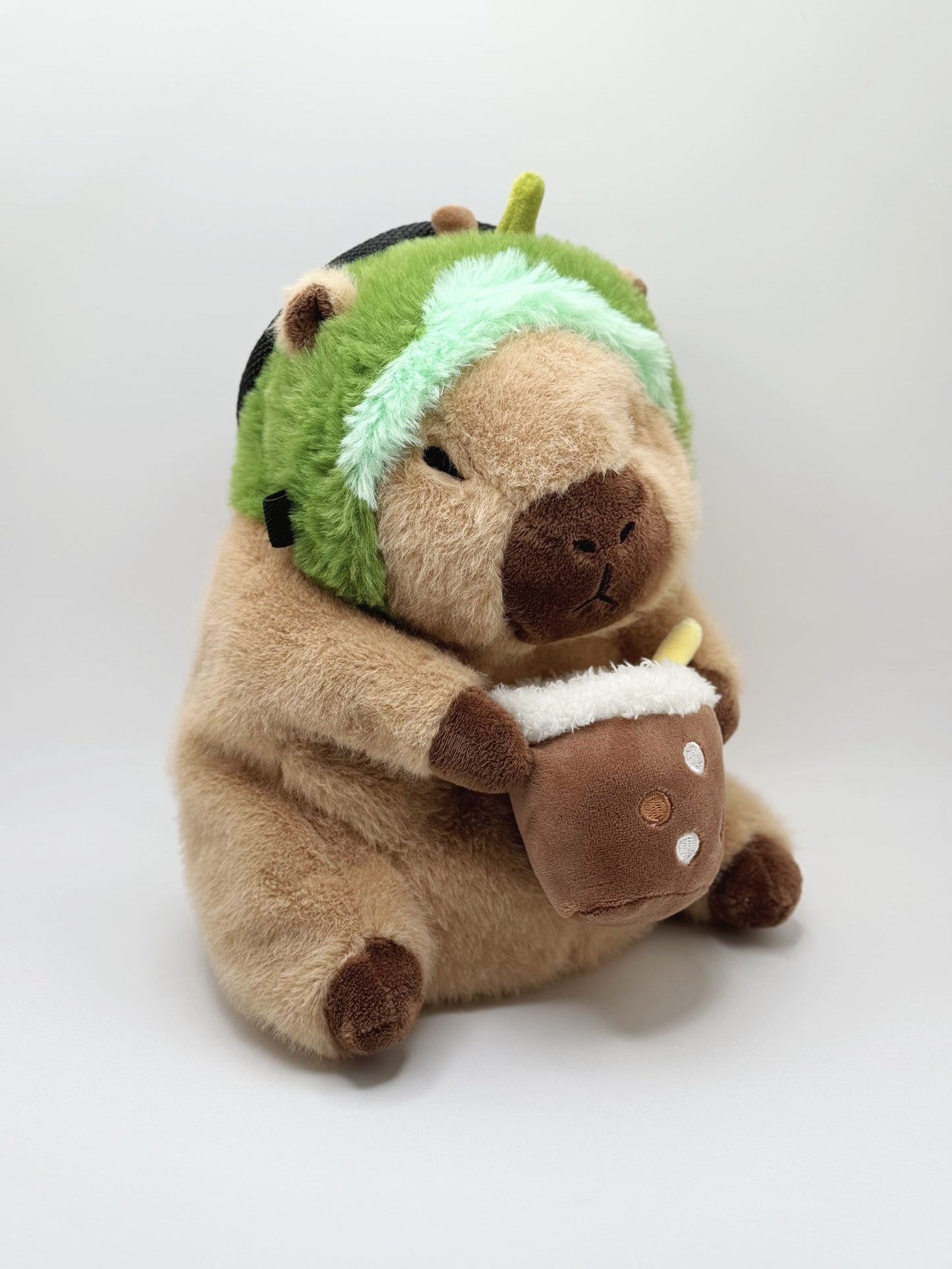 Handmade capybara-shaped climbing chalk bag dressed as avocado clutching a bubble tea cup