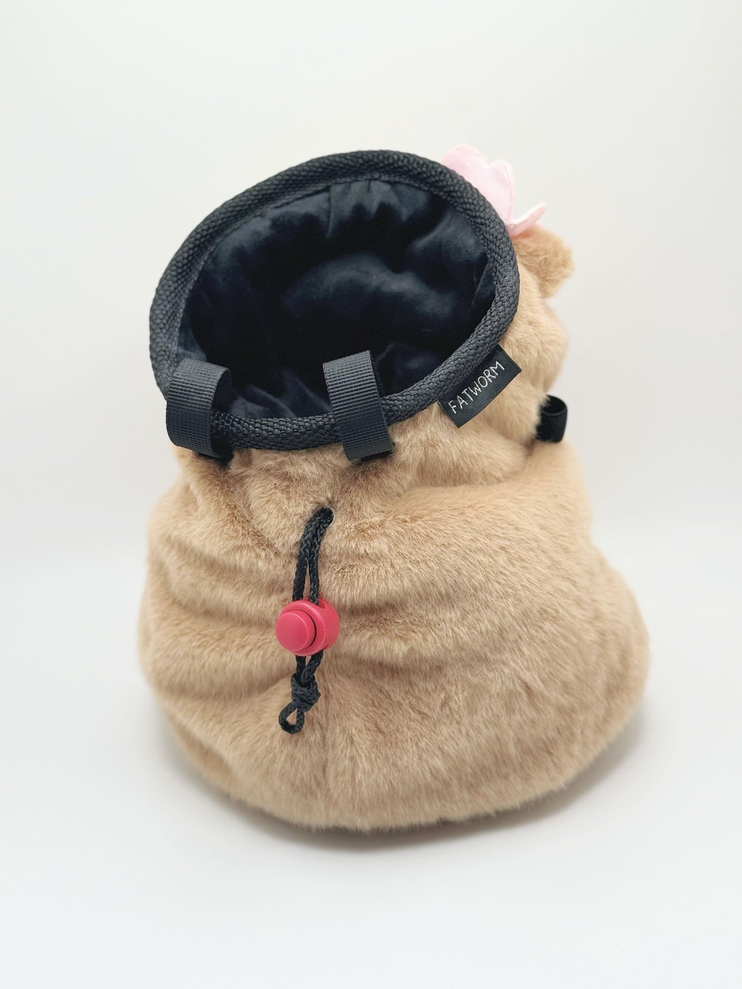 Handmade chalk bag featuring an adorable baby capybara holding a pink flower and wearing a cute dress-up outfit. Soft plush design, perfect for climbing and bouldering. Made by Fatworm