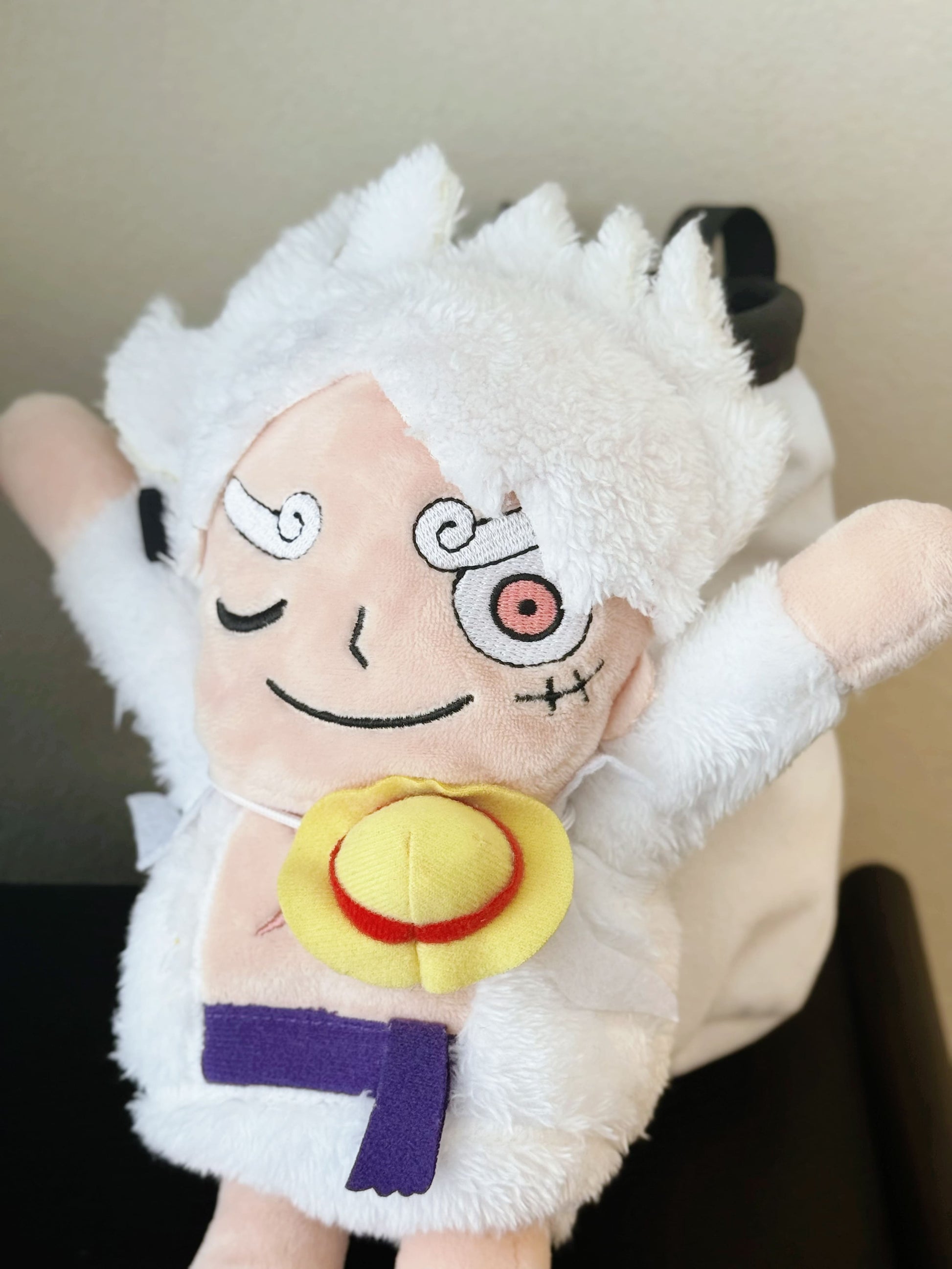 Luffy's Gear 5 transformation from One Piece Nika anime Climbing plush chalk bag, Functional climbing accessory with wide elastic opening and drawstring closure for bouldering or rock climbing.