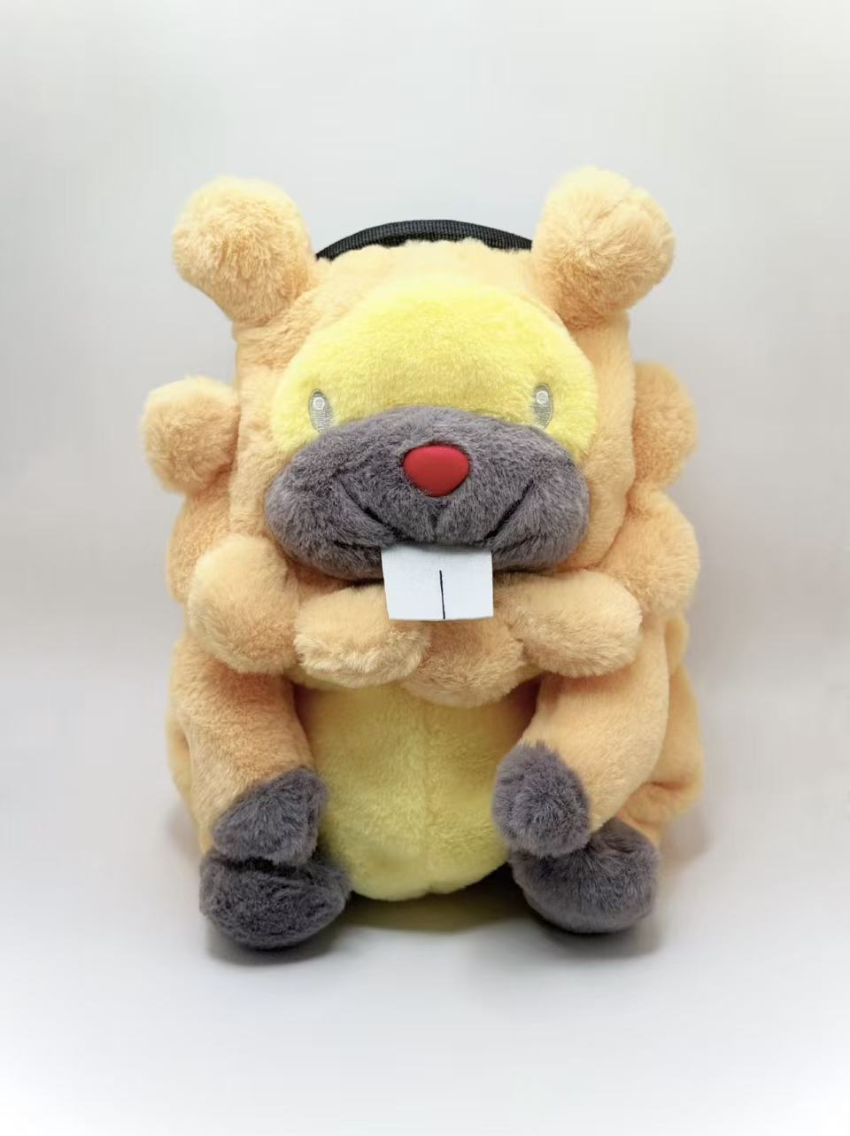 A cute, handmade plush climbing chalk bag made of extra-soft, fluffy material featuring Bidoof with chubby cheeks and iconic front teeth. Designed with high functionality by a climber, it includes a wide top rim opening, polar fleece lining, a brush loop, and a spill-proof drawstring. A great bouldering gift for rock climbers