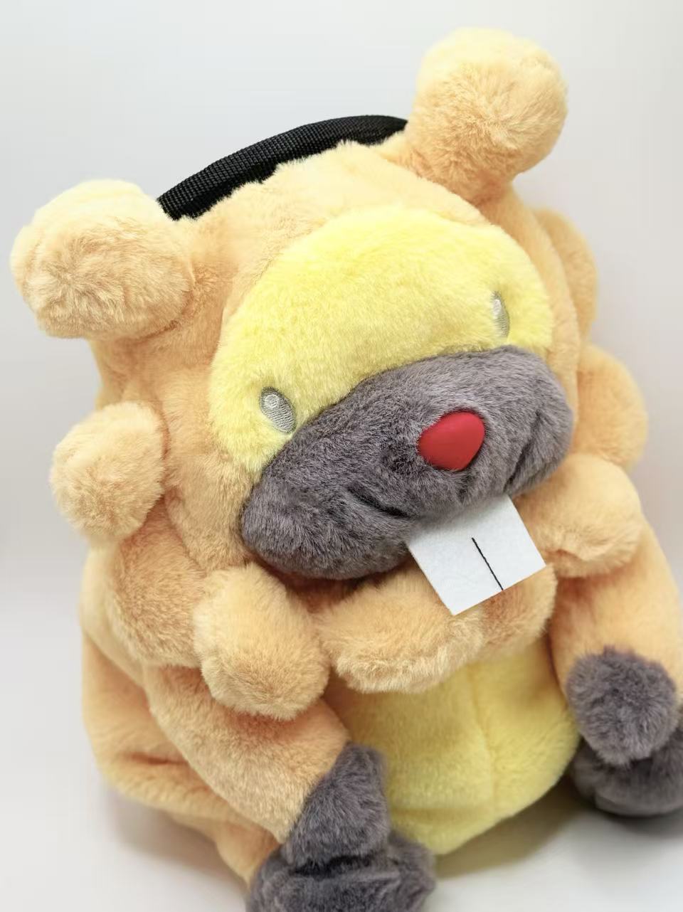 A cute, handmade plush climbing chalk bag made of extra-soft, fluffy material featuring Bidoof with chubby cheeks and iconic front teeth. Designed with high functionality by a climber, it includes a wide top rim opening, polar fleece lining, a brush loop, and a spill-proof drawstring. A great bouldering gift for rock climbers