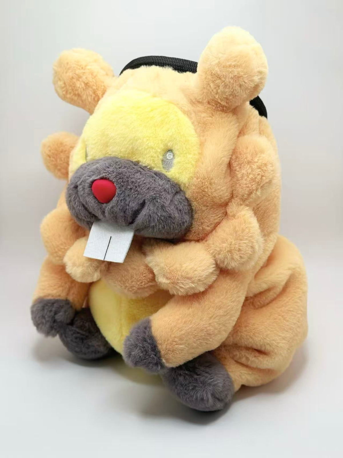 A cute, handmade plush climbing chalk bag made of extra-soft, fluffy material featuring Bidoof with chubby cheeks and iconic front teeth. Designed with high functionality by a climber, it includes a wide top rim opening, polar fleece lining, a brush loop, and a spill-proof drawstring. A great bouldering gift for rock climbers