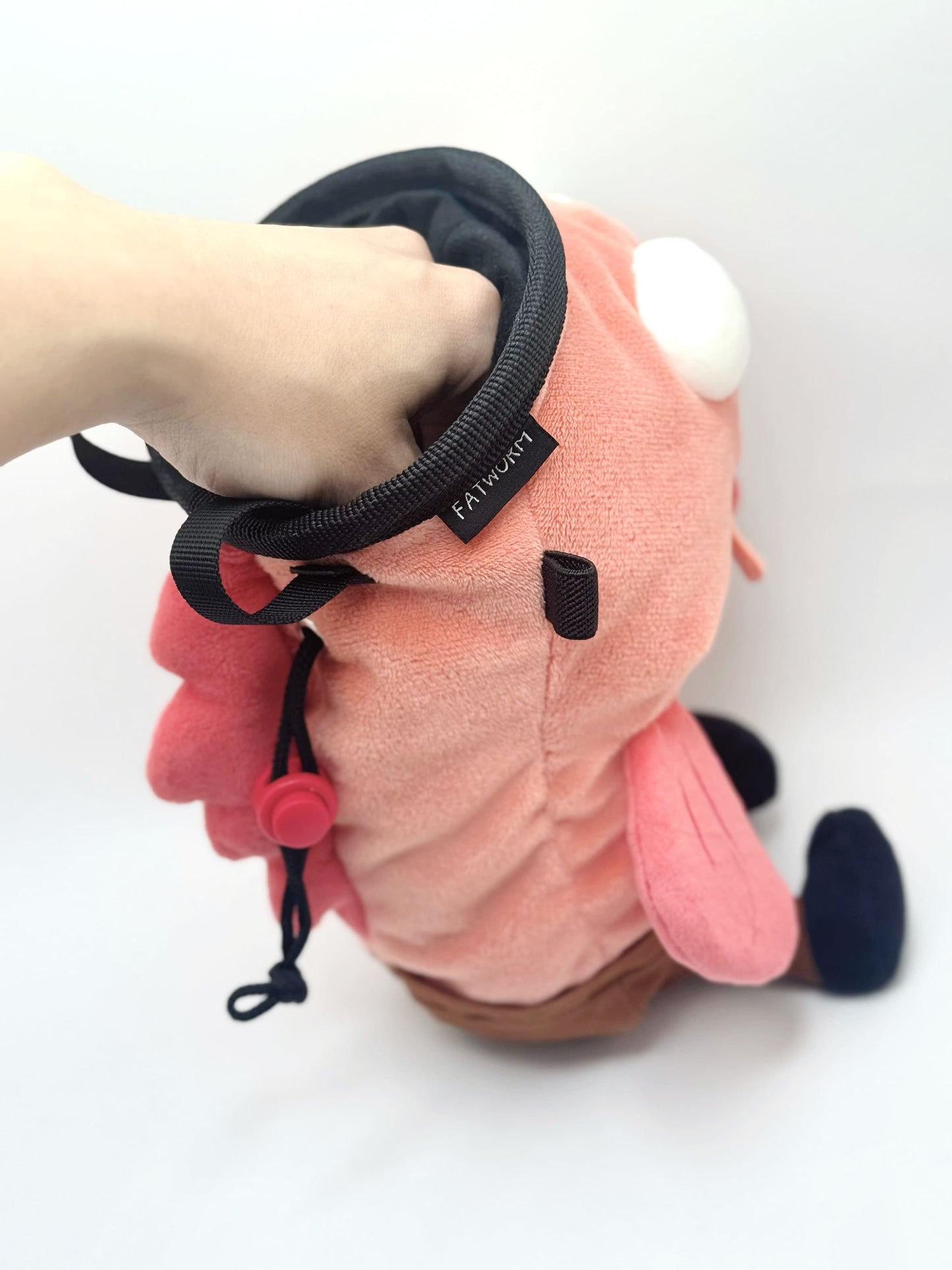 Dazed mocha brown and pink fish design on a cute plush chalk bag for rock climbing. Shows wide shocked eyes,  and a functional stiffened rim. A unique climbing gift for climbers.