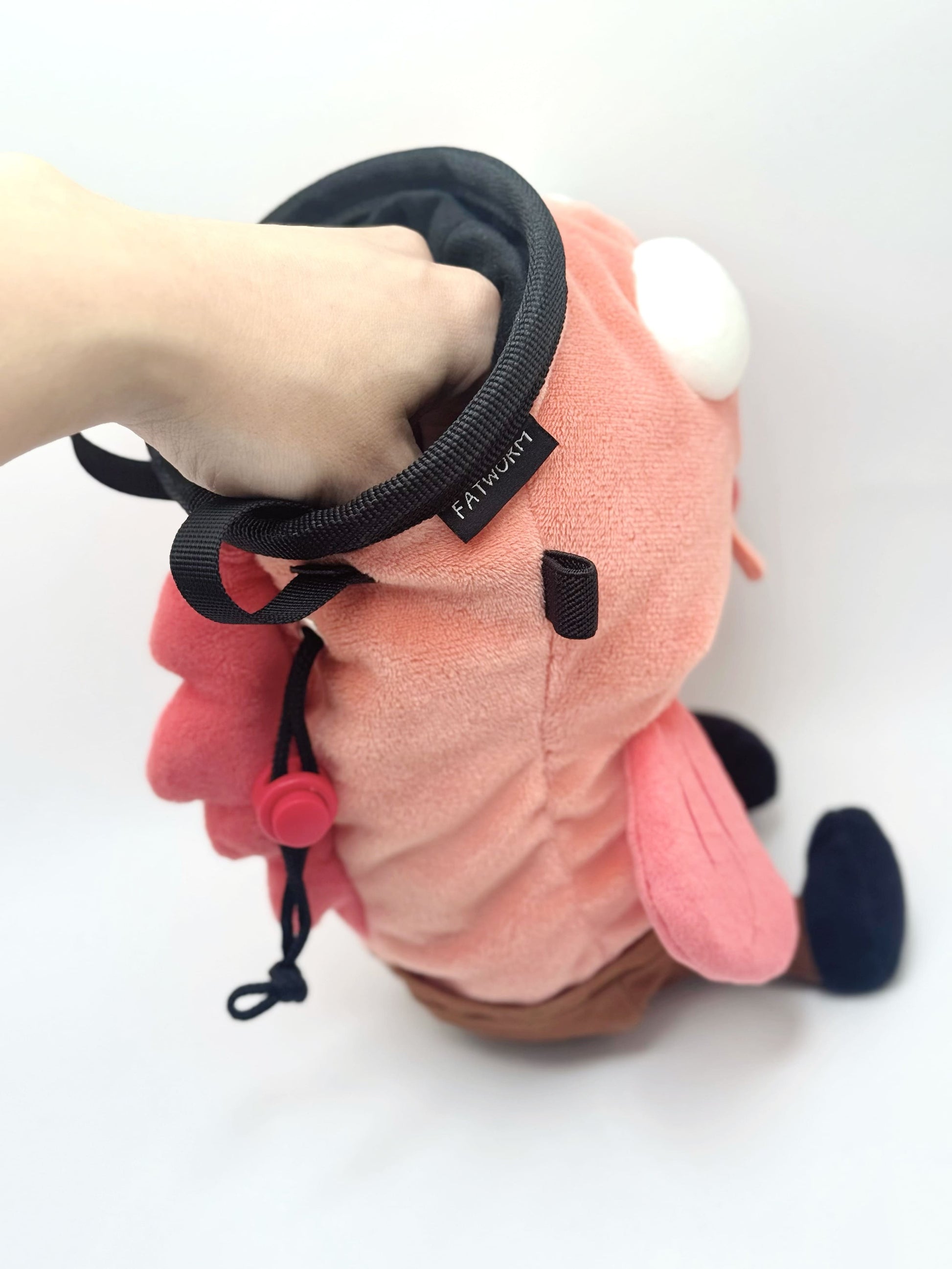 Dazed mocha brown and pink fish design on a cute plush chalk bag for rock climbing. Shows wide shocked eyes,  and a functional stiffened rim. A unique climbing gift for climbers.
