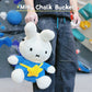 A cute anime plush miffy chalk bag by FATWORM featuring a white Vanilla Bunny wearing a blue dress and a yellow star backpack. This functional and fluffy bouldering accessory is handmade for bouldering and climbing for rock climbing, offering a long-durable design that makes the perfect climbing gift for a climber.