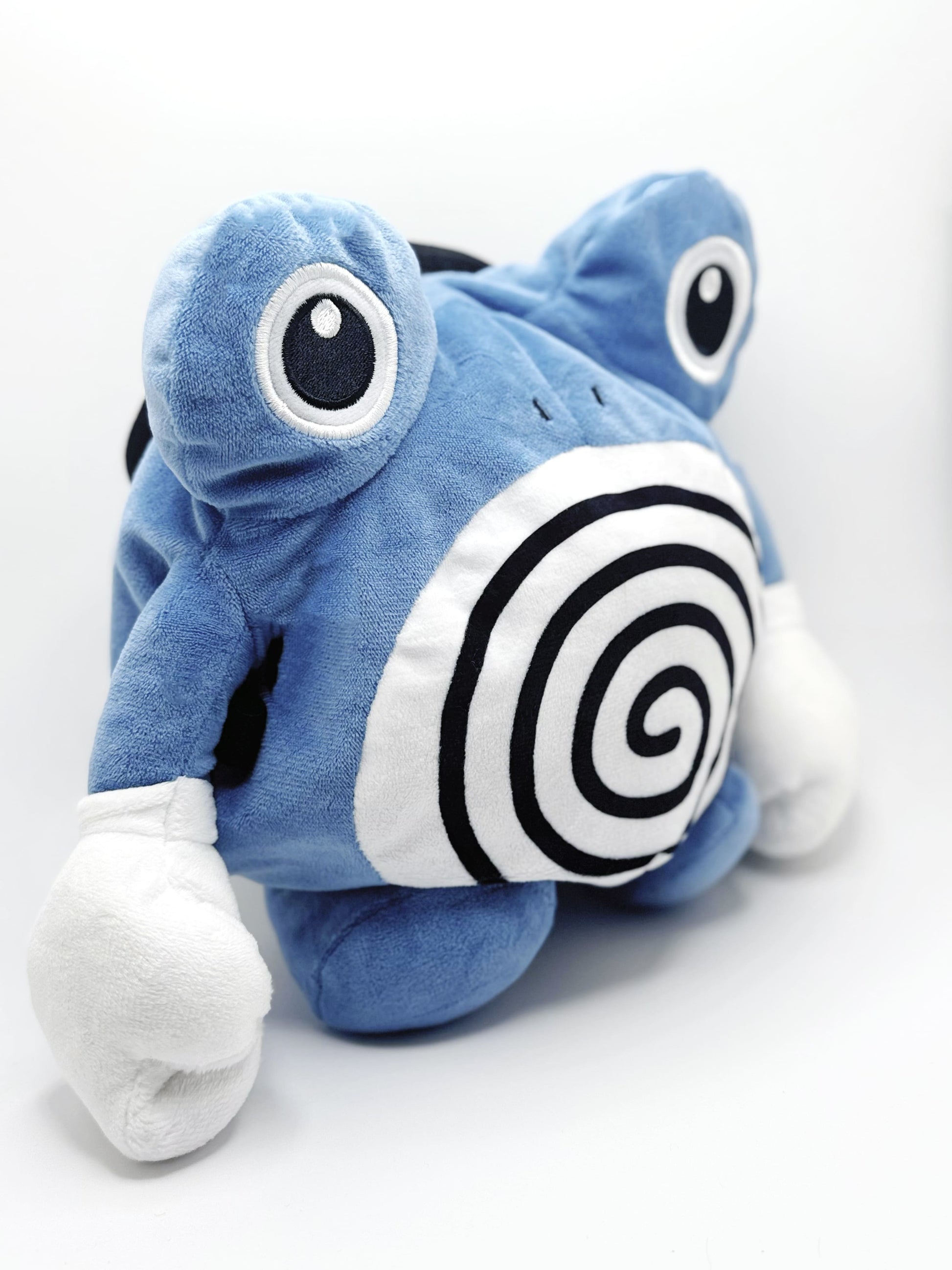 A cute anime plush chalk bag by FATWORM featuring a blue tadpole with a black and white swirl on its belly and white gloves. This functional and fluffy bouldering accessory is handmade for bouldering and climbing for rock climbing, offering a long-durable design that makes the perfect climbing gift for a climber.