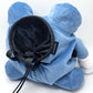 A cute anime plush chalk bag by FATWORM featuring a blue tadpole with a black and white swirl on its belly and white gloves. This functional and fluffy bouldering accessory is handmade for bouldering and climbing for rock climbing, offering a long-durable design that makes the perfect climbing gift for a climber.