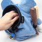 A cute anime plush chalk bag by FATWORM featuring a blue tadpole with a black and white swirl on its belly and white gloves. This functional and fluffy bouldering accessory is handmade for bouldering and climbing for rock climbing, offering a long-durable design that makes the perfect climbing gift for a climber.