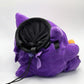 A cute anime plush chalk bag by Fatworm featuring Gengar holding a peanut. This functional and fluffy accessory is handmade for bouldering and climbing for rock climbing, offering a long-durable design that makes the perfect climbing gift for a climber.