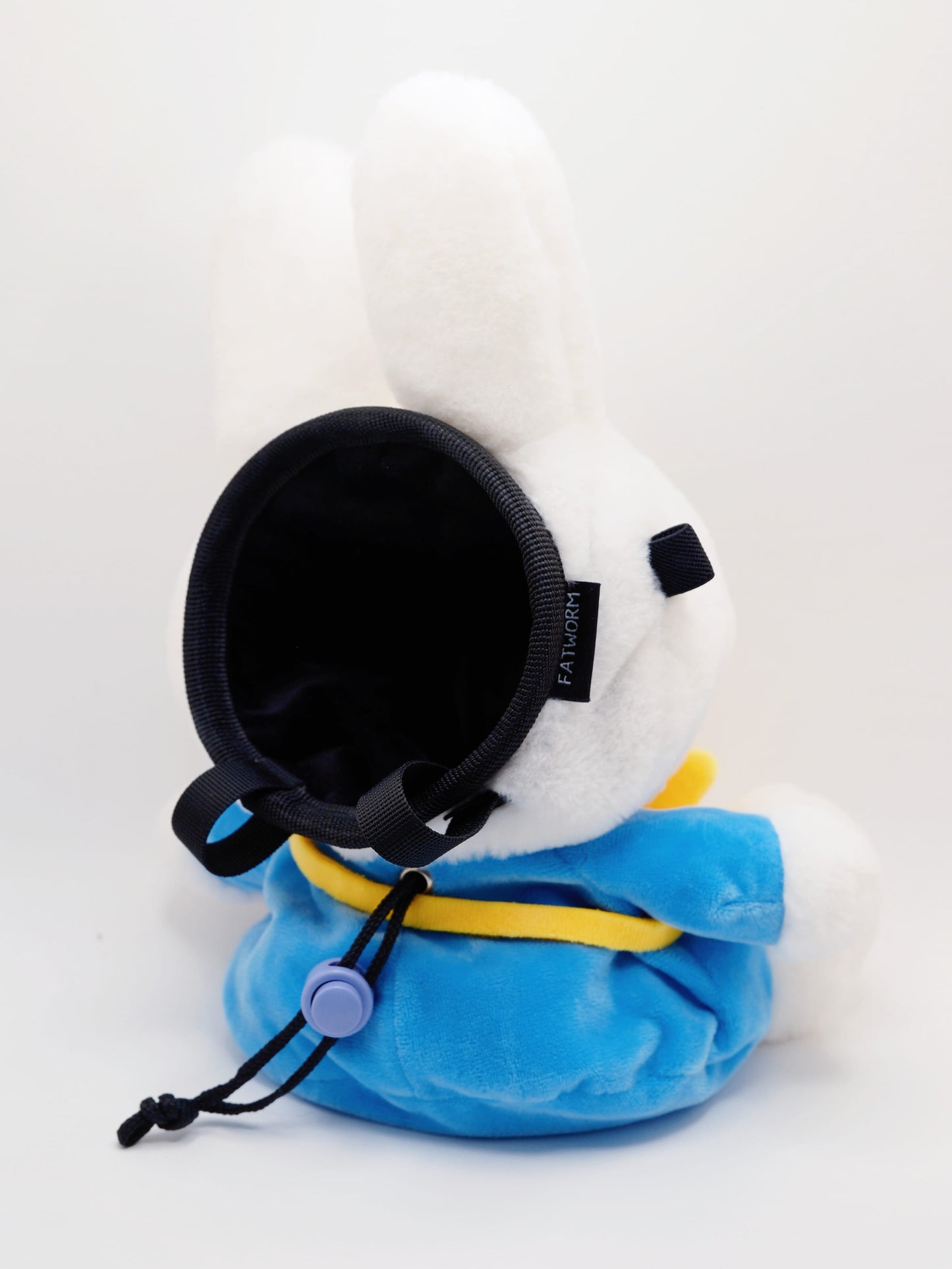 A cute anime plush chalk bag by FATWORM featuring a white Vanilla Bunny wearing a blue dress and a yellow star backpack. This functional and fluffy bouldering accessory is handmade for bouldering and climbing for rock climbing, offering a long-durable design that makes the perfect climbing gift for a climber.