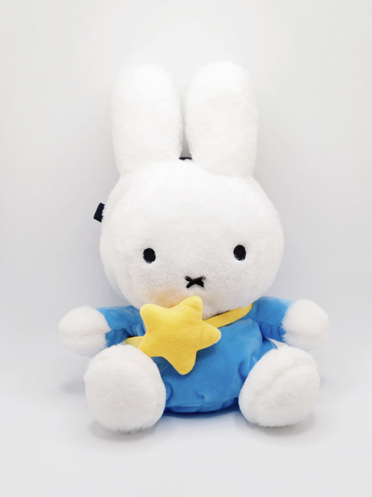 A cute anime plush chalk bag by FATWORM featuring a white Vanilla Bunny wearing a blue dress and a yellow star backpack. This functional and fluffy bouldering accessory is handmade for bouldering and climbing for rock climbing, offering a long-durable design that makes the perfect climbing gift for a climber.