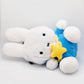 A cute anime plush chalk bag by FATWORM featuring a white Vanilla Bunny wearing a blue dress and a yellow star backpack. This functional and fluffy bouldering accessory is handmade for bouldering and climbing for rock climbing, offering a long-durable design that makes the perfect climbing gift for a climber.