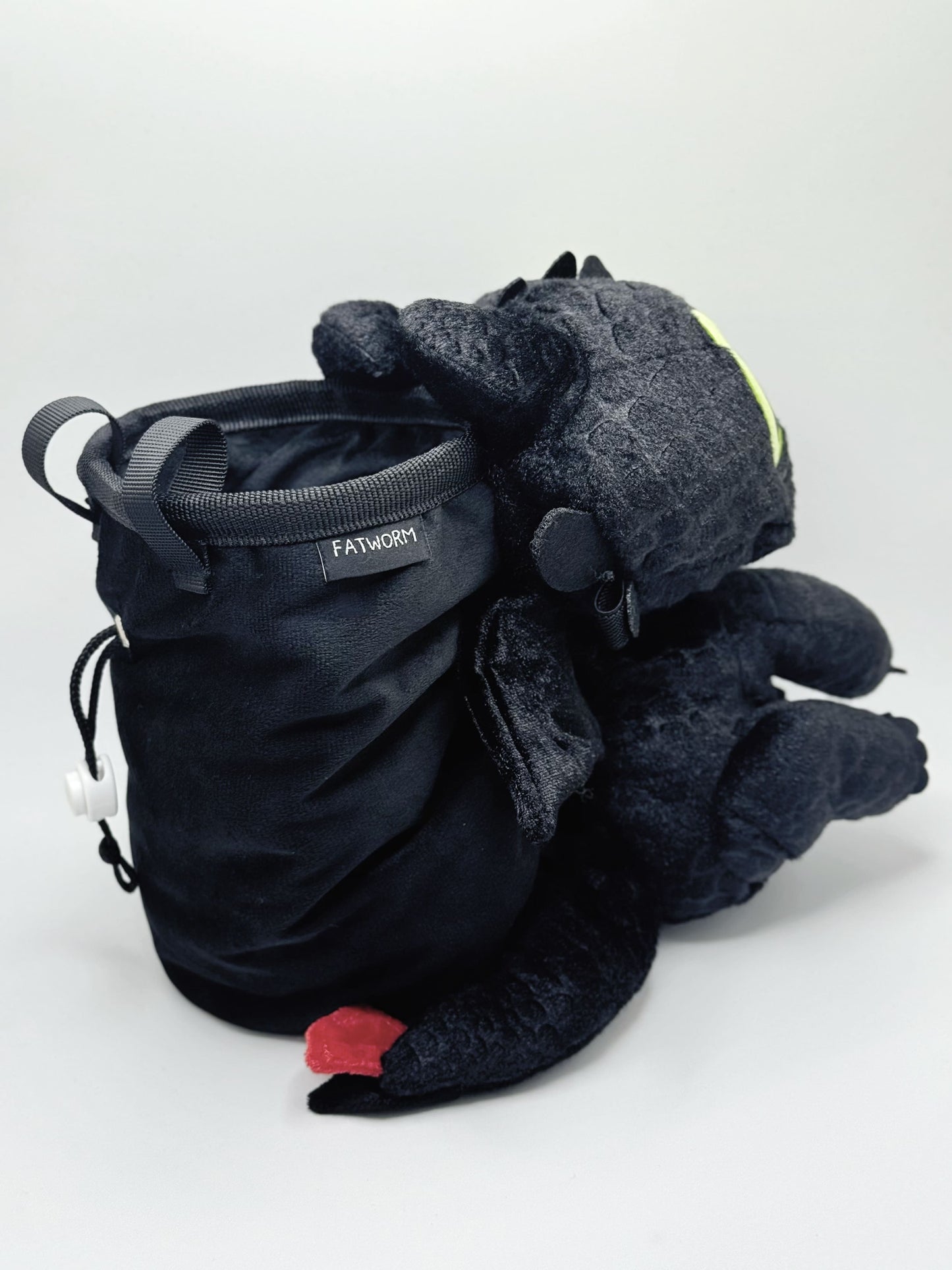 Baby Toothless dragon chalk bag for rock climbing and bouldering, featuring green eyes and Night Fury wings on black plush fabric.
