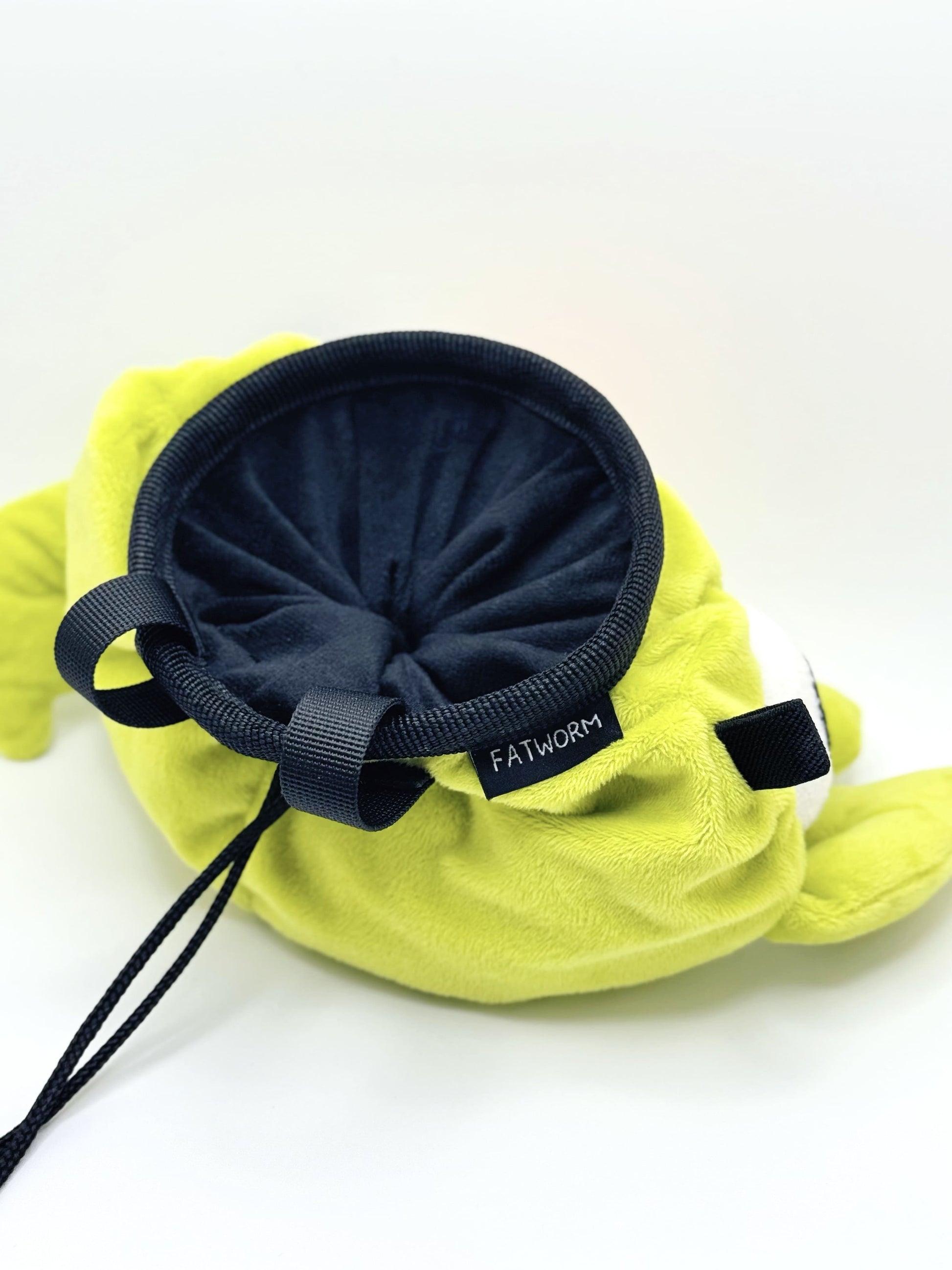 Soft plush climbing chalk bag shaped like a green game mascot with embroidered eyes. Inspired by the character Bing Bong from the co-op climbing video game PEAK. Handmade climbing chalk bag for bouldering and gym use by Fatworm