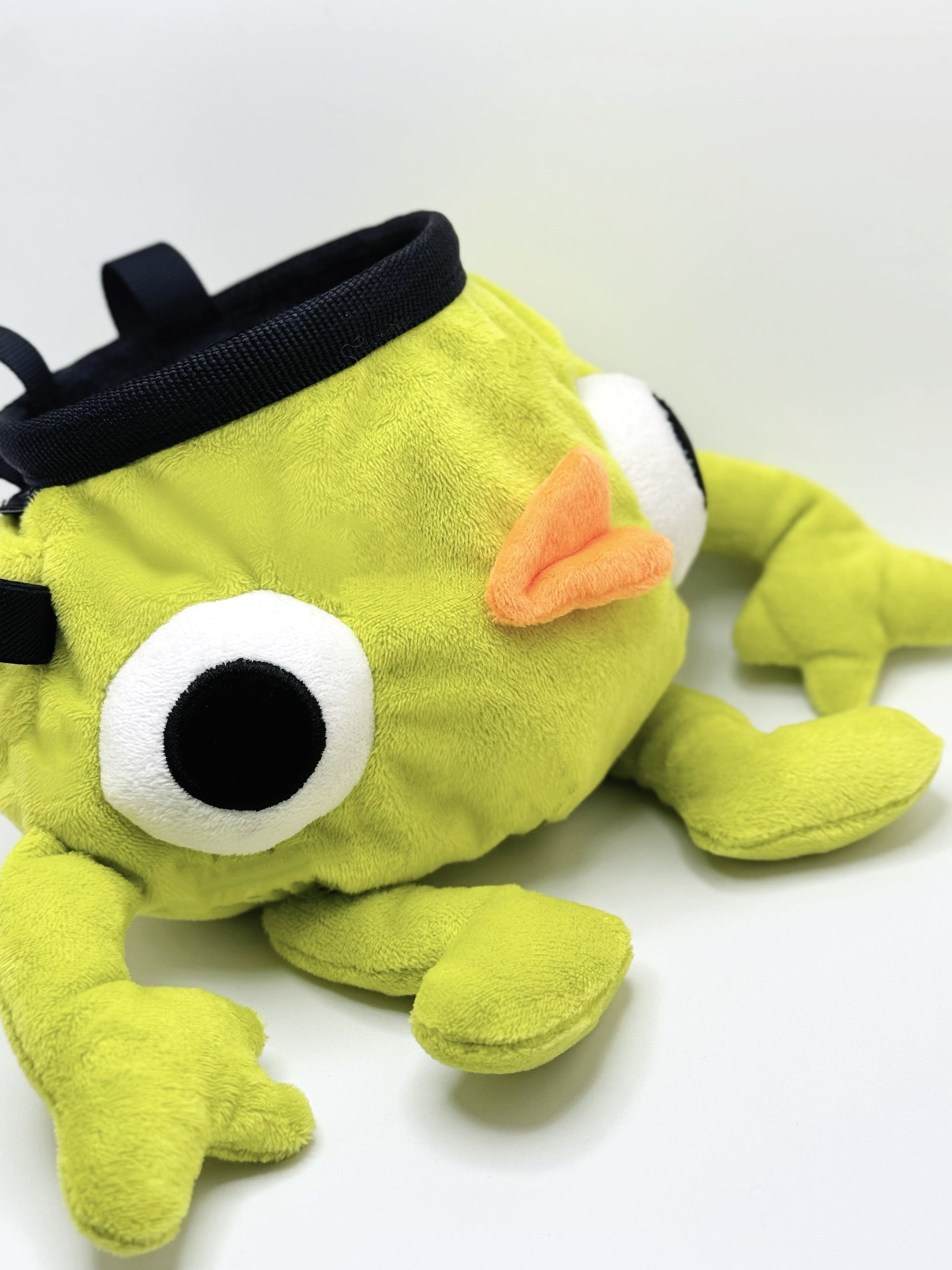 Soft plush climbing chalk bag shaped like a green game mascot with embroidered eyes. Inspired by the character Bing Bong from the co-op climbing video game PEAK. Handmade climbing chalk bag for bouldering and gym use by Fatworm