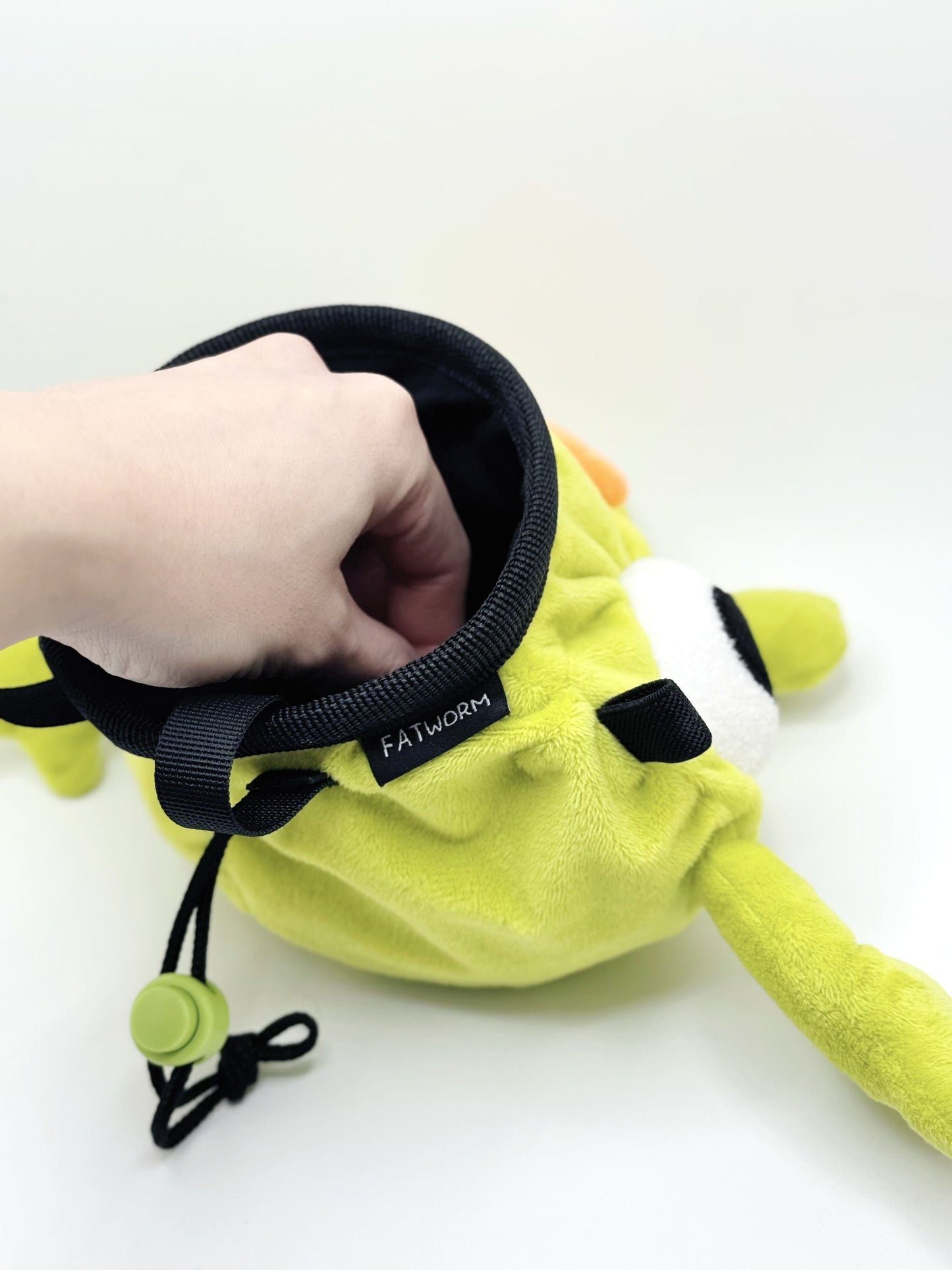 Soft plush climbing chalk bag shaped like a green game mascot with embroidered eyes. Inspired by the character Bing Bong from the co-op climbing video game PEAK. Handmade climbing chalk bag for bouldering and gym use by Fatworm