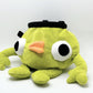Soft plush climbing chalk bag shaped like a green game mascot with embroidered eyes. Inspired by the character Bing Bong from the co-op climbing video game PEAK. Handmade climbing chalk bag for bouldering and gym use by Fatworm