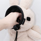 Handmade cream-colored Milk Tea Bunny plush climbing chalk bag with long floppy ears. Cute bouldering gift featuring a reinforced 12cm rim, secure drawstring, and deep black fleece lining. High-performance bouldering gear by Fatworm.