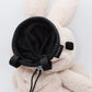 Handmade cream-colored Milk Tea Bunny plush climbing chalk bag with long floppy ears. Cute bouldering gift featuring a reinforced 12cm rim, secure drawstring, and deep black fleece lining. High-performance bouldering gear by Fatworm.