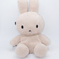 Handmade cream-colored Milk Tea Bunny plush climbing chalk bag with long floppy ears. Cute bouldering gift featuring a reinforced 12cm rim, secure drawstring, and deep black fleece lining. High-performance bouldering gear by Fatworm.
