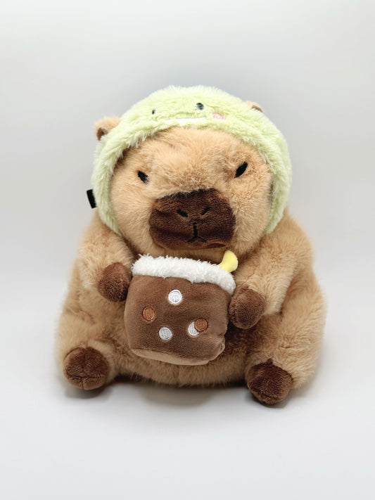 Handmade capybara-shaped climbing chalk bag dressed as a dinosaur, clutching a bubble tea cup