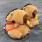 Handmade brown plush capybara climbing chalk bag wearing a red M backpack with removable plush fries. Unique bouldering gift featuring a reinforced 12cm rim and deep black fleece lining. Cute and funny bouldering gear by Fatworm.
