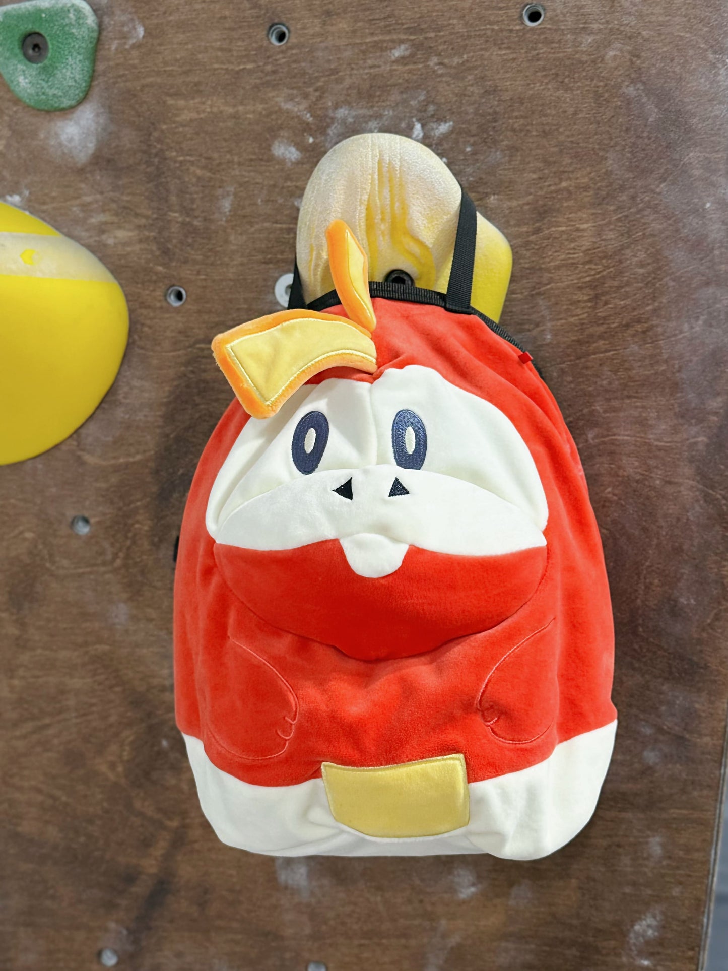 Pokémon Fuecoco climbing chalk bag/bucket featuring a soft plush exterior, spacious opening, and a stretchy brush holder, designed for rock climbers, handmade by Fatworm.