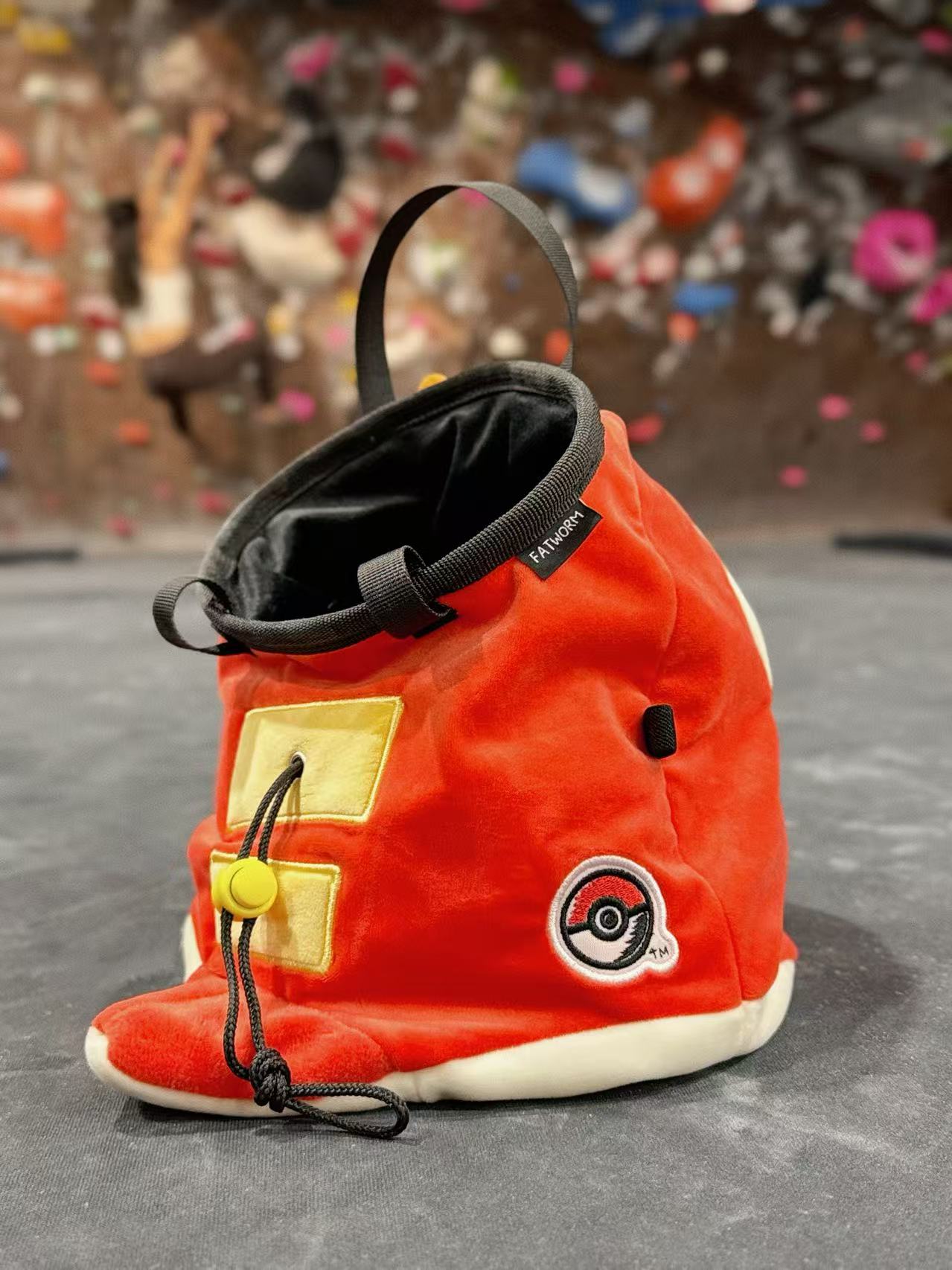 Pokémon Fuecoco climbing chalk bag/bucket featuring a soft plush exterior, spacious opening, and a stretchy brush holder, designed for rock climbers, handmade by Fatworm.