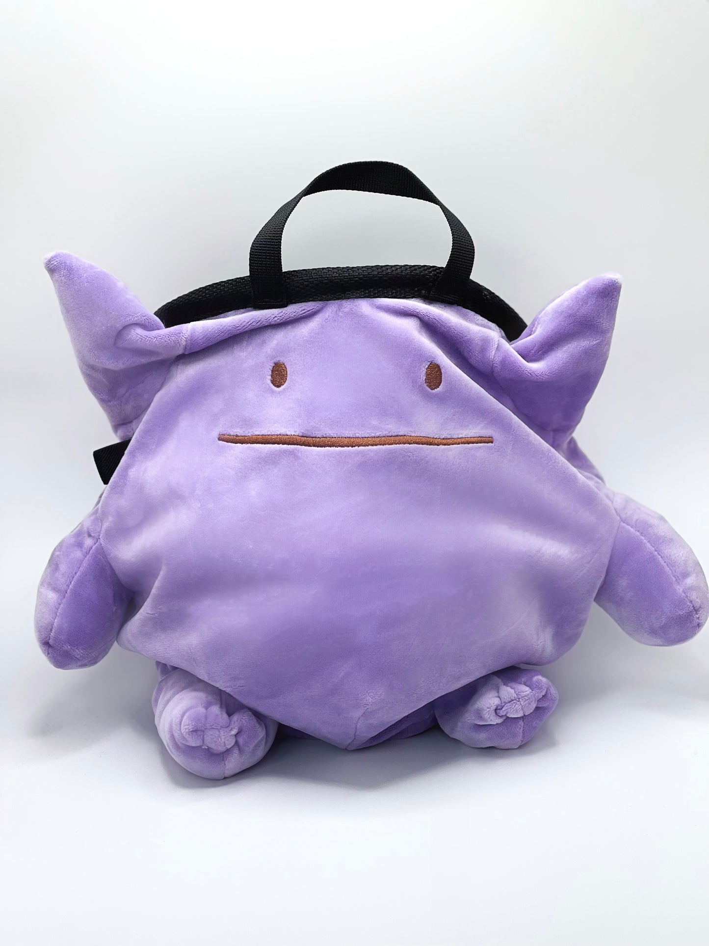A cute, handmade plush climbing chalk bag featuring Ditto transformed into Gengar, with a purple ghost shape and Ditto’s iconic simple face. Designed with high functionality by a climber, it includes a wide top rim opening, polar fleece lining, a brush loop, and a spill-proof drawstring. A great bouldering gift for rock climbers.