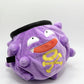 A cute anime plush chalk bag designed like Koffing by Fatworm. This functional purple bouldering and climbing accessory is handmade with a soft exterior, secure drawstring, and brush loop, making it perfect for rock climbing and a great gear addition for any climber.