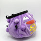A cute anime plush chalk bag designed like Koffing by Fatworm. This functional purple bouldering and climbing accessory is handmade with a soft exterior, secure drawstring, and brush loop, making it perfect for rock climbing and a great gear addition for any climber.