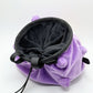 A cute anime plush chalk bag designed like Koffing by Fatworm. This functional purple bouldering and climbing accessory is handmade with a soft exterior, secure drawstring, and brush loop, making it perfect for rock climbing and a great gear addition for any climber.