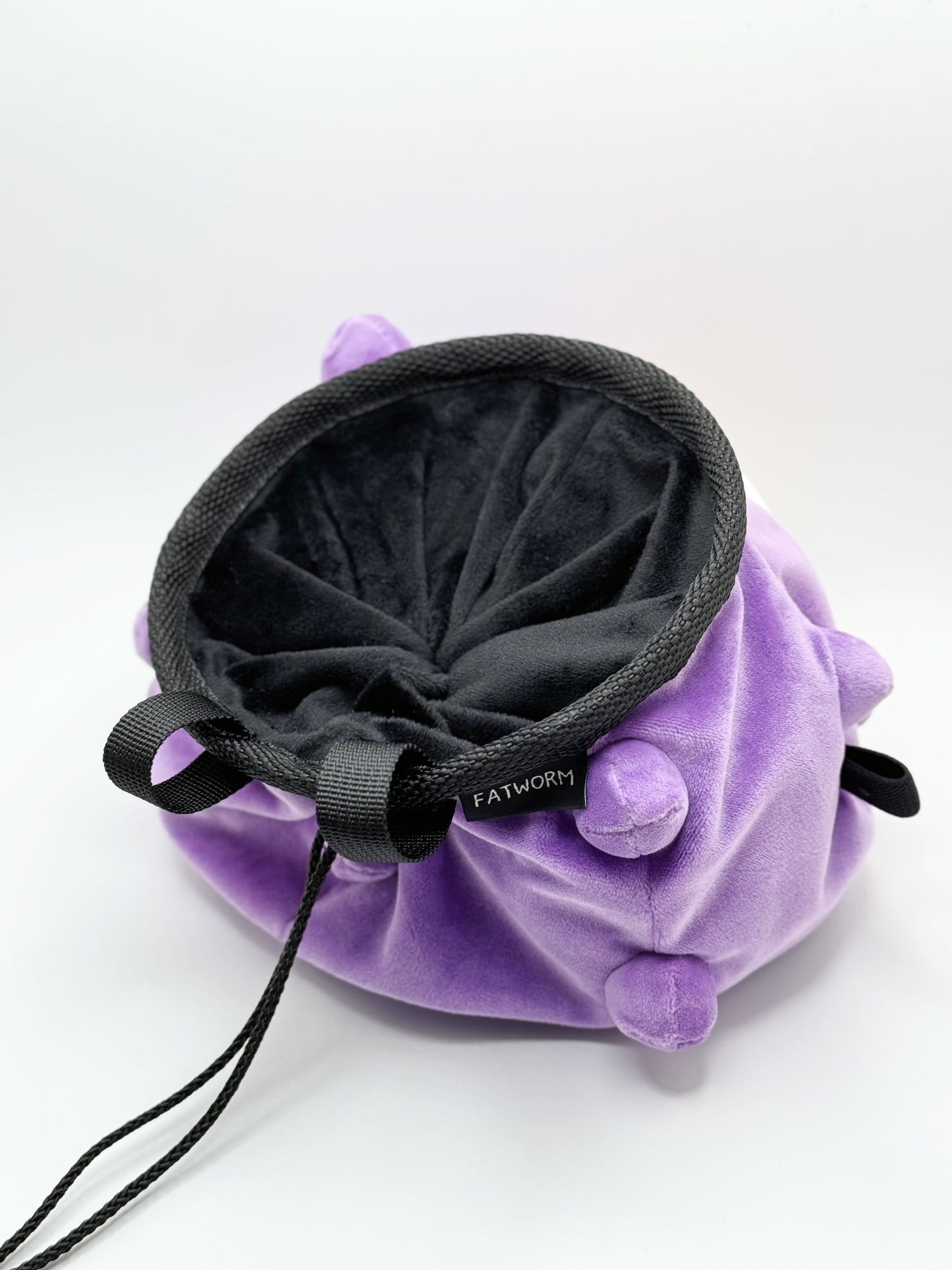 A cute anime plush chalk bag designed like Koffing by Fatworm. This functional purple bouldering and climbing accessory is handmade with a soft exterior, secure drawstring, and brush loop, making it perfect for rock climbing and a great gear addition for any climber.