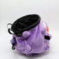 A cute anime plush chalk bag designed like Koffing by Fatworm. This functional purple bouldering and climbing accessory is handmade with a soft exterior, secure drawstring, and brush loop, making it perfect for rock climbing and a great gear addition for any climber.