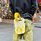 A cute anime plush chalk bag by Fatworm inspired by a famous fast food brand. This red functional bag features a vibrant yellow handle, a secure closure to prevent chalk spills, and a long-durable design, making it the perfect climbing gift for a climber into bouldering and climbing for rock climbing.