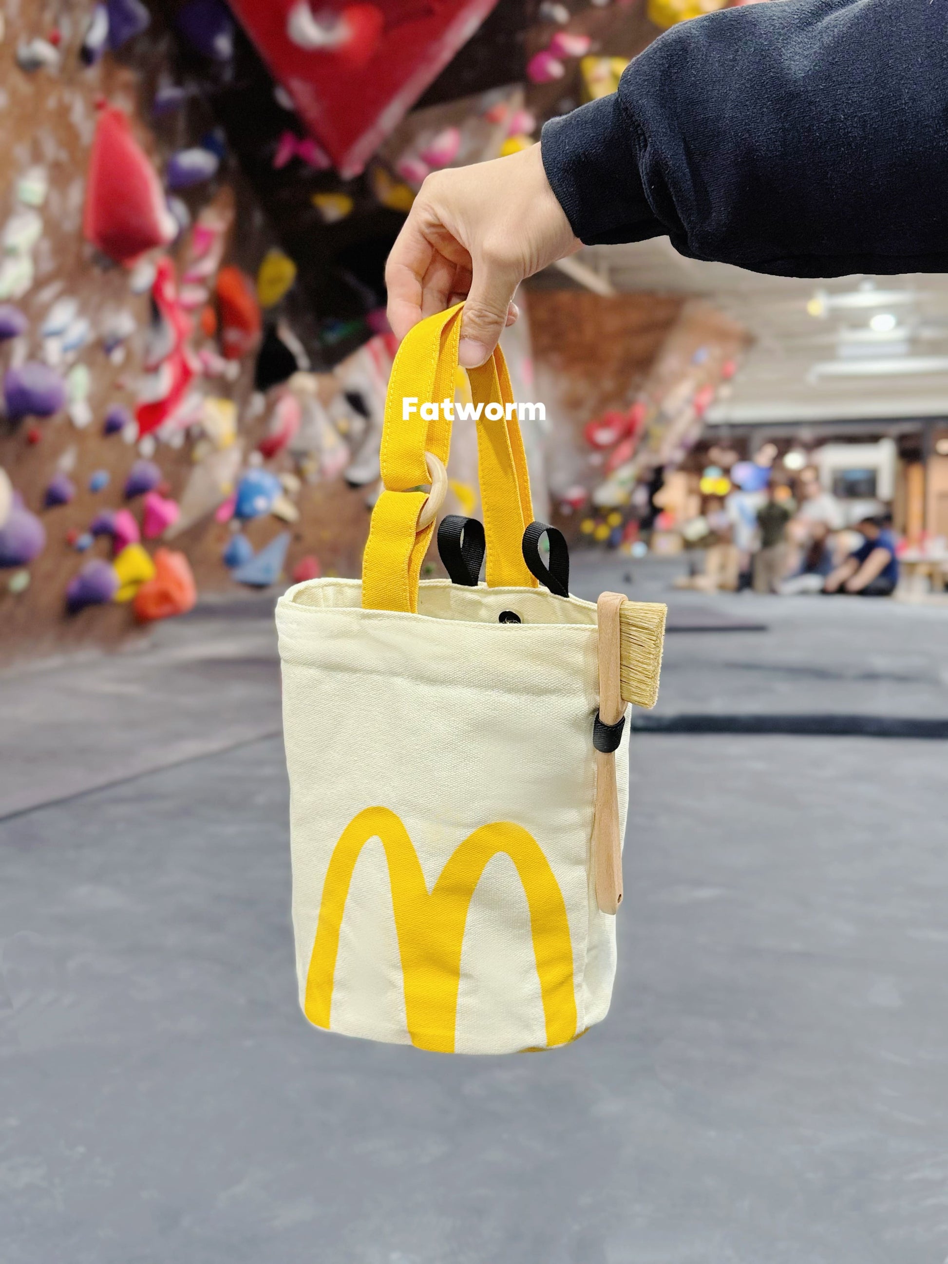 A cute anime plush chalk bag by Fatworm inspired by a famous fast food brand. This red functional bag features a vibrant yellow handle, a secure closure to prevent chalk spills, and a long-durable design, making it the perfect climbing gift for a climber into bouldering and climbing for rock climbing.