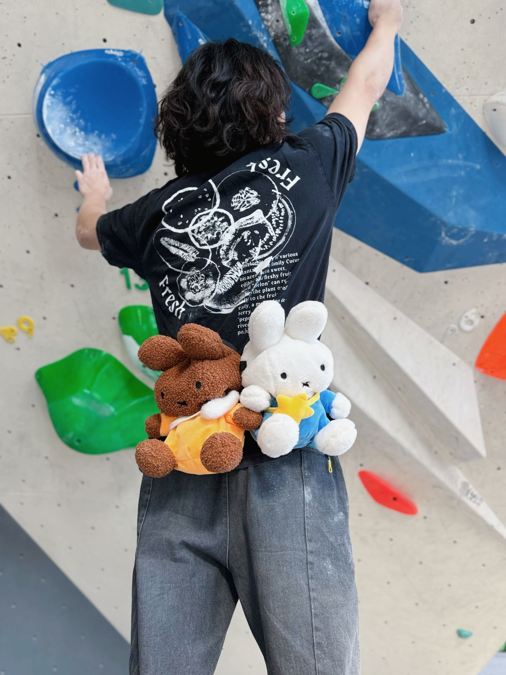 A cute anime plush miffy chalk bag by FATWORM featuring a white Vanilla Bunny wearing a blue dress and a yellow star backpack. This functional and fluffy bouldering accessory is handmade for bouldering and climbing for rock climbing, offering a long-durable design that makes the perfect climbing gift for a climber.