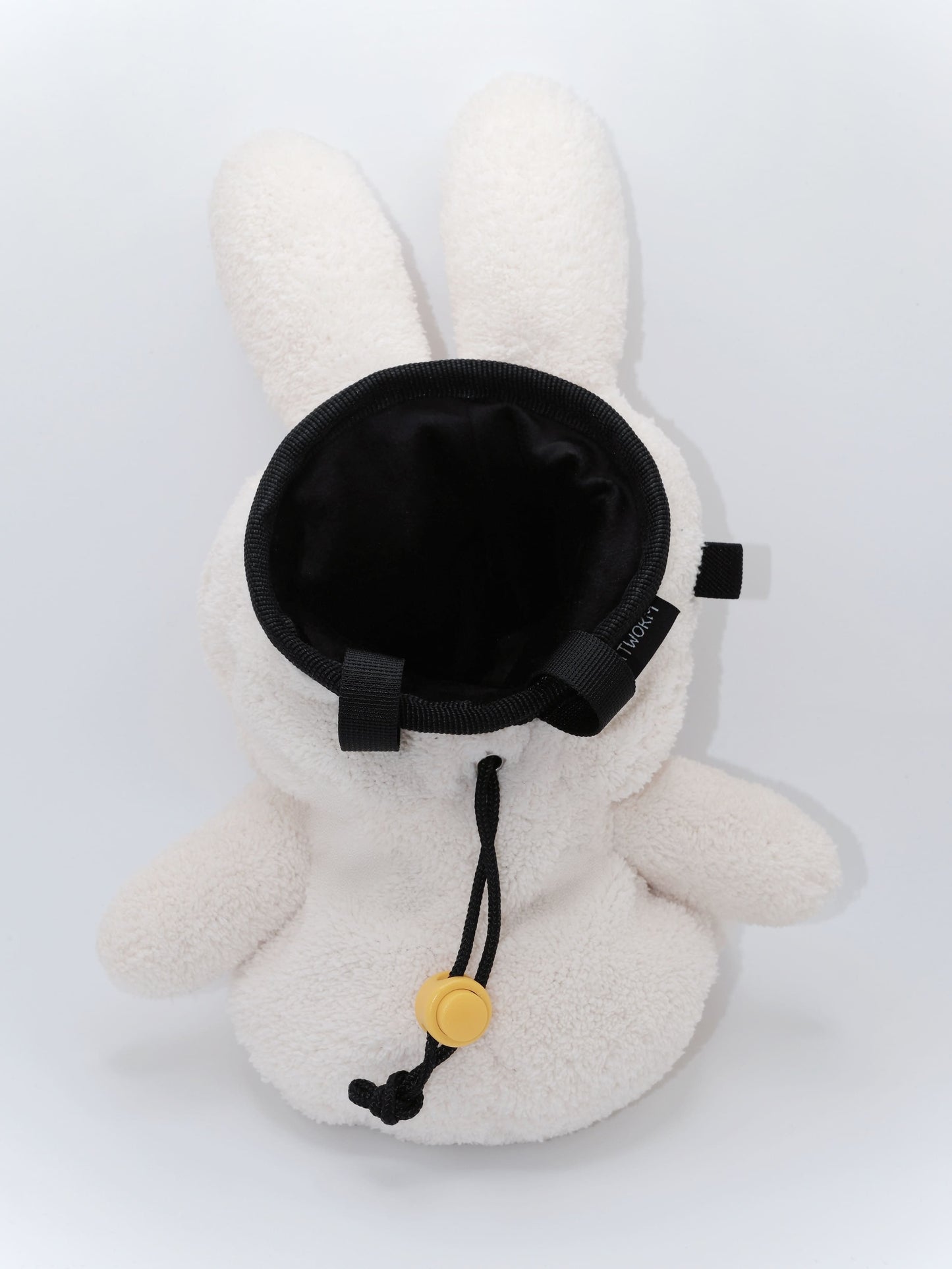 Cream beige plush Miffy climbing chalk bag featuring a cute bunny face; functional Fatworm Chalkbag gear.