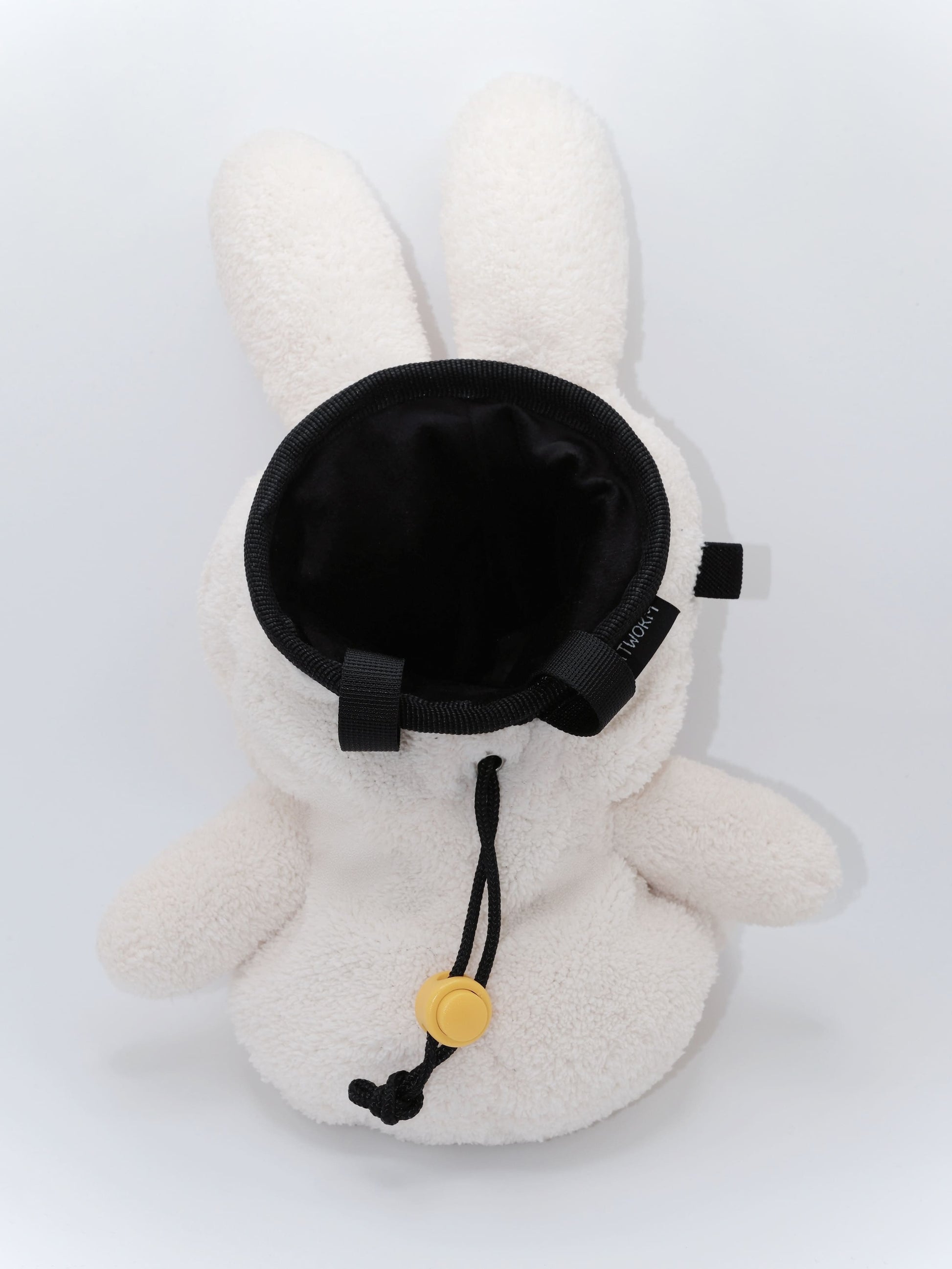 Cream beige plush Miffy climbing chalk bag featuring a cute bunny face; functional Fatworm Chalkbag gear.