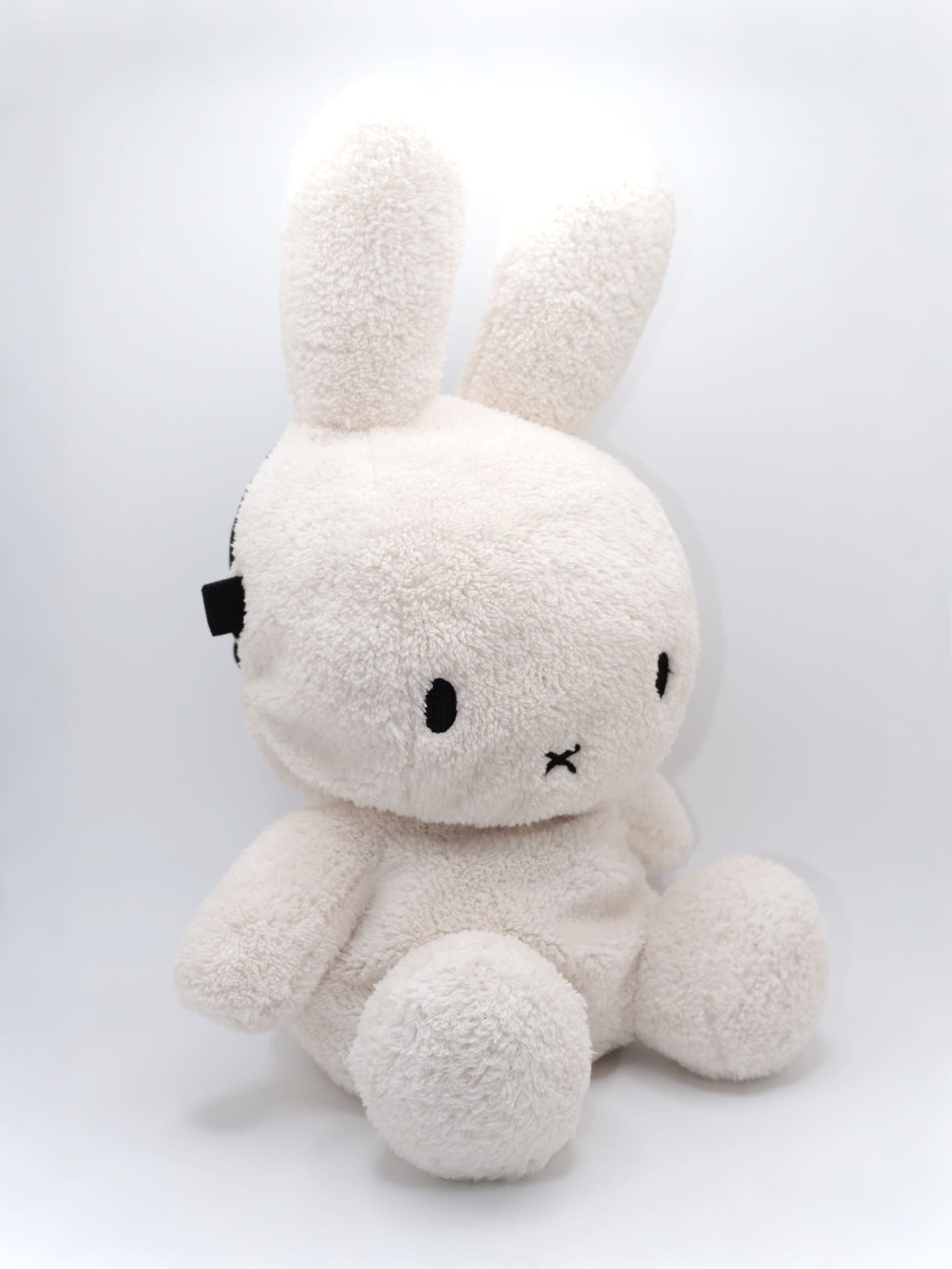 Cream beige plush Miffy climbing chalk bag featuring a cute bunny face; functional Fatworm Chalkbag gear.