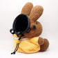 A cute anime plush chalk bag by FATWORM featuring a brown Mocha Bunny wearing a yellow dress. This functional and fluffy bouldering accessory is handmade for bouldering and climbing for rock climbing, offering a long-durable design that makes the perfect climbing gift for a climber.