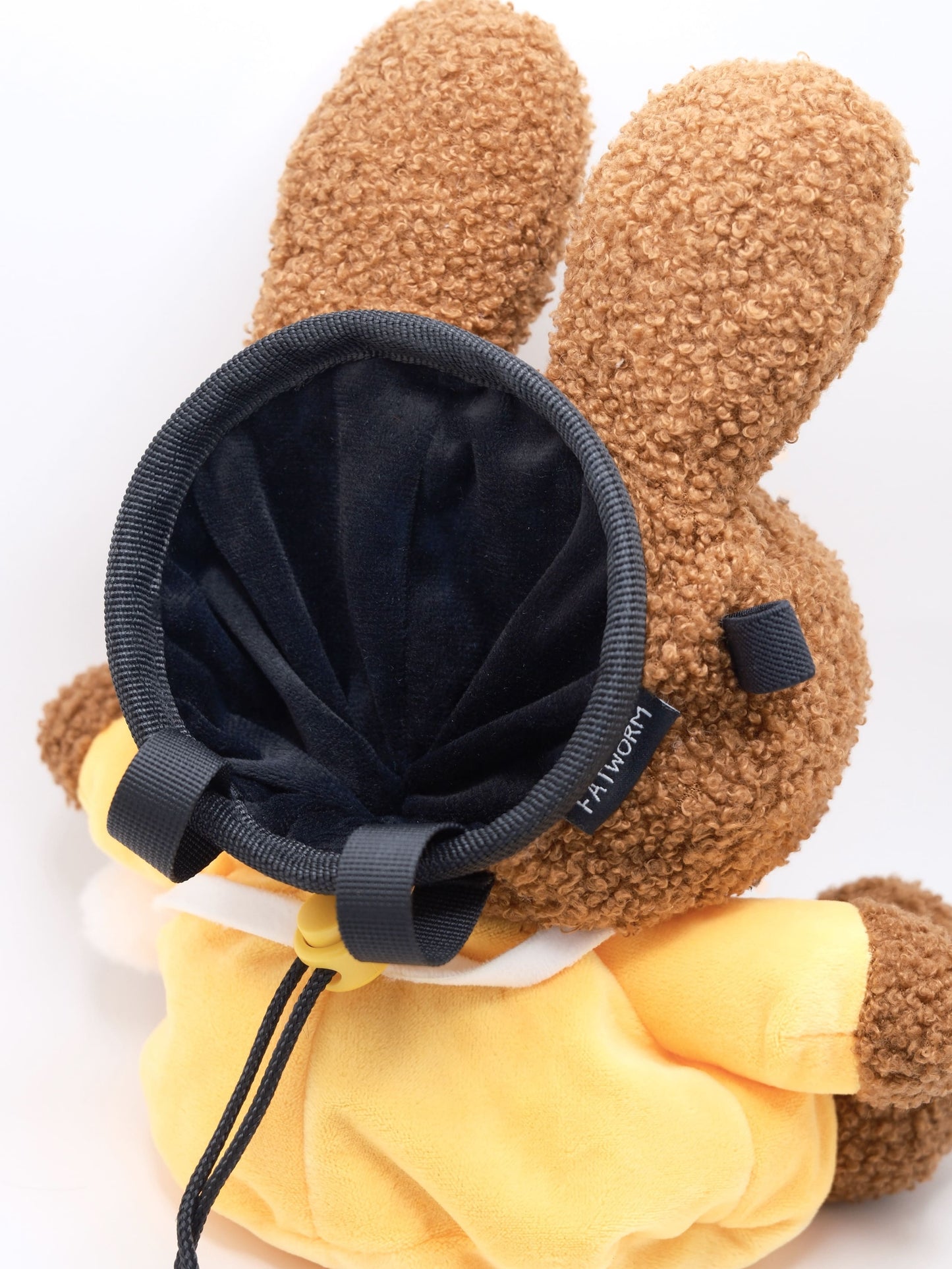 A cute anime plush chalk bag by FATWORM featuring a brown Mocha Bunny wearing a yellow dress. This functional and fluffy bouldering accessory is handmade for bouldering and climbing for rock climbing, offering a long-durable design that makes the perfect climbing gift for a climber.