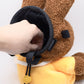 A cute anime plush chalk bag by FATWORM featuring a brown Mocha Bunny wearing a yellow dress. This functional and fluffy bouldering accessory is handmade for bouldering and climbing for rock climbing, offering a long-durable design that makes the perfect climbing gift for a climber.