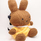 A cute anime plush chalk bag by FATWORM featuring a brown Mocha Bunny wearing a yellow dress. This functional and fluffy bouldering accessory is handmade for bouldering and climbing for rock climbing, offering a long-durable design that makes the perfect climbing gift for a climber.