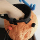 A cute anime plush chalk bag by FATWORM featuring an orange magical fire fruit with swirling flame patterns and a green stem, inspired by the fiery hero Ace. This functional and fluffy bouldering accessory is handmade for bouldering and climbing for rock climbing, offering a long-durable design that makes the perfect climbing gift for a climber.
