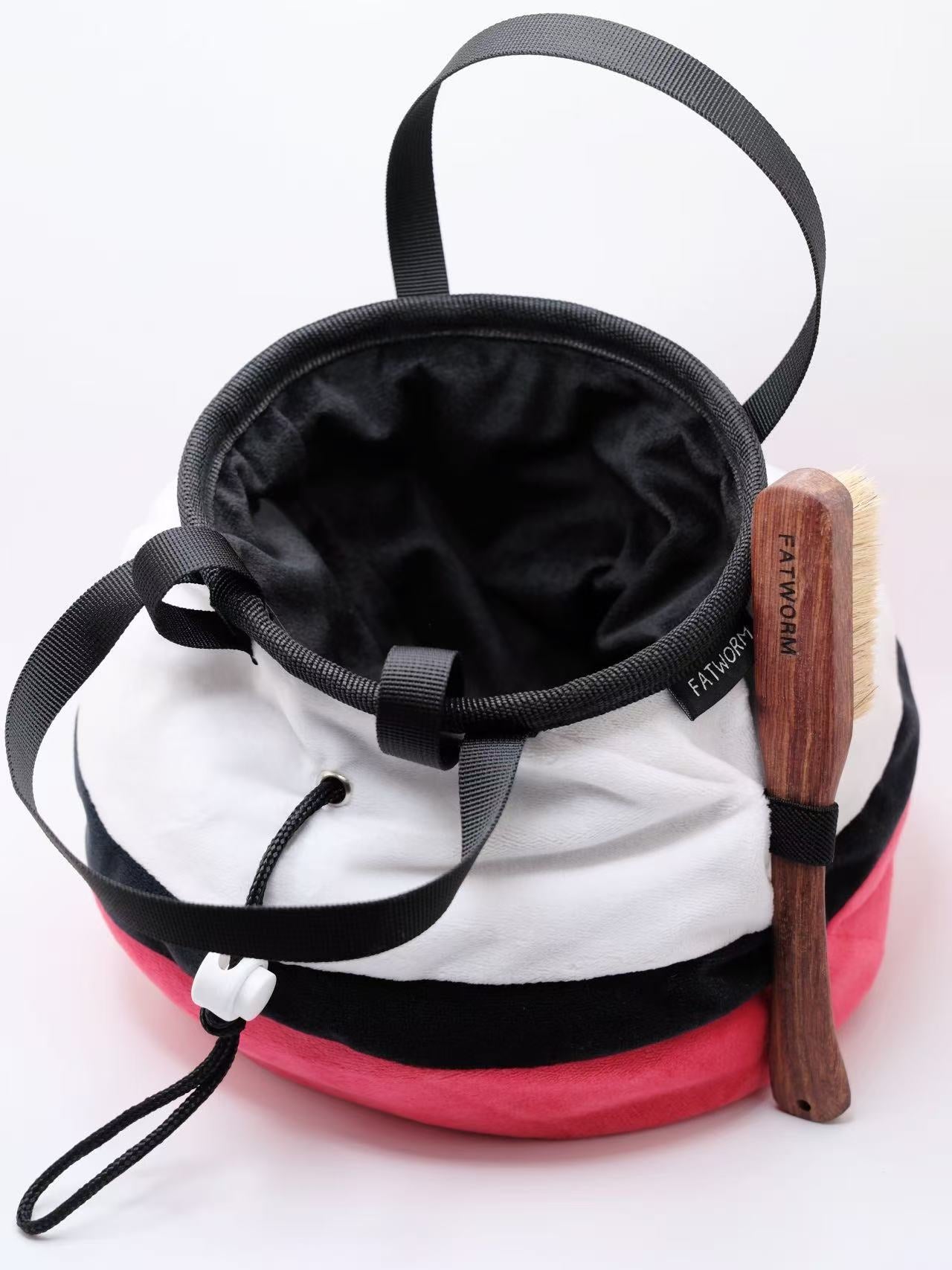 A soft and fluffy Poke Ball plush chalk bag by Fatworm. This cute yet functional climbing gear features the iconic red, white, and black design in a long-durable handmade construction. The perfect climbing gift for climbers who love gaming accessories.