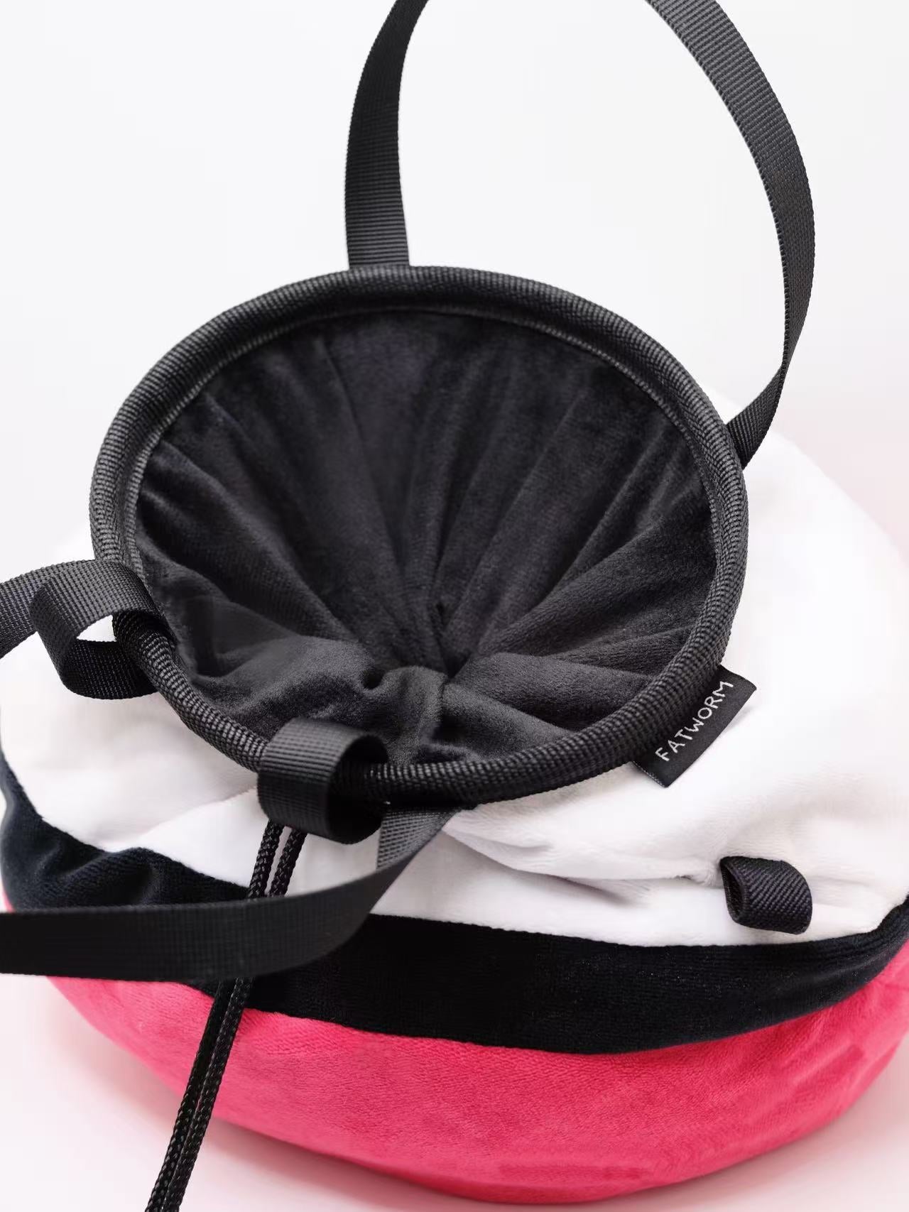 A soft and fluffy Poke Ball plush chalk bag by Fatworm. This cute yet functional climbing gear features the iconic red, white, and black design in a long-durable handmade construction. The perfect climbing gift for climbers who love gaming accessories.